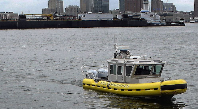 A boat capable of autonomous navigation makes its way around Boston Harbor (AP photo)