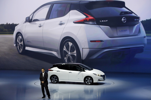 In this Wednesday, Sept. 6, 2017 file photo, Nissan President and CEO Hiroto Saikawa unveils its new Leaf electric vehicle during the world premiere in Chiba, Japan. The Renault-Nissan alliance is ramping up electric car production, vowing 12 new models by 2022 and to make electric cars 30 percent of its overall production. (AP Photo/Eugene Hoshiko, File)