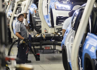 Workers produce vehicles at Volkswagen's lone U.S. plant in Chattanooga, Tenn. U.S. industrial output plunged 0.9 percent in August, the most in eight years, mostly because of Hurricane Harvey's damage to the oil refining, plastics and chemicals industries. (AP Photo/Erik Schelzig, File)