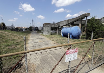A gate at the U.S. Oil Recovery Superfund site is shown Thursday, Sept. 14, 2017, in Pasadena, Texas, where three tanks once used to store toxic waste were flooded during Hurricane Harvey. The Environmental Protection Agency says it has found no evidence that toxins washed off the site, but is still assessing damage. (AP Photo)