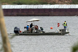 A boat with a dive flag is shown at San Jacinto River Waste Pits near the Interstate 10 bridge over the river in Channelview, Texas. The Environmental Protection Agency says an unknown amount of a dangerous chemical linked to birth defects and cancer may have washed downriver from a Houston-area Superfund site during the flooding from Hurricane Harvey. (AP Photo/David J. Phillip)