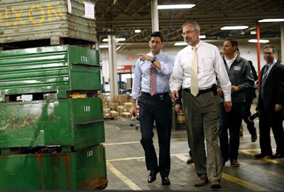 Speaker of the House Paul Ryan, R-Wis., left, and Rep. Andy Harris, R-Md., right, approach a stage before holding a tax reform town hall with employees at the Dixon Valve & Coupling Company factory in Chestertown, Md., Thursday, Oct. 5, 2017. (AP Photo/Patrick Semansky)