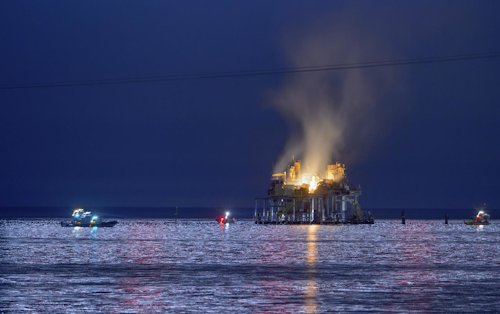Jefferson Parish, La., authorities and others from other parishes respond to an oil rig explosion in Lake Pontchartrain off Kenner, La., Sunday, Oct. 15, 2017. (Matthew Hinton/The Advocate via AP)