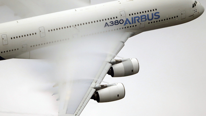 In this June 18 2015 file photo, vapour forms across the wings of an Airbus A380 as it performs a demonstration flight at the Paris Air Show, Le Bourget airport, north of Paris. Airbus shares have risen thanks to an unusual no-cost deal with Canada's Bombardier that has angered U.S. rival Boeing. (AP Photo/Francois Mori, File)