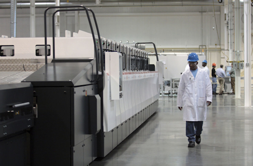In this Sept. 16, 2011, file photograph, an employee walks past part of the production line at the Stion global manufacturing facility in Hattiesburg, Miss. The company, which produces solar panels, was expected to bring about 1,000 jobs to Mississippi once it began manufacturing at full capacity, but instead notified the state Tuesday, Oct. 17, 2017, that it would close its Hattiesburg plant Dec. 13. Mississippi initially loaned Stion $74.8 million, and governments have given millions more in other tax breaks and subsidies. (Bryant Hawkins/Hattiesburg American, via AP, File)