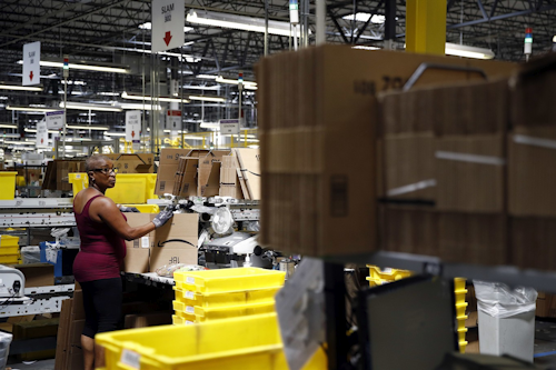 Cynthia Richburg prepares a product for shipment at an Amazon fulfillment center in Baltimore. While jobs have been lost in brick-and-mortar stores, many more have been gained from e-commerce and warehousing. Amazon accounts for much of the additional employment. (AP Photo/Patrick Semansky)