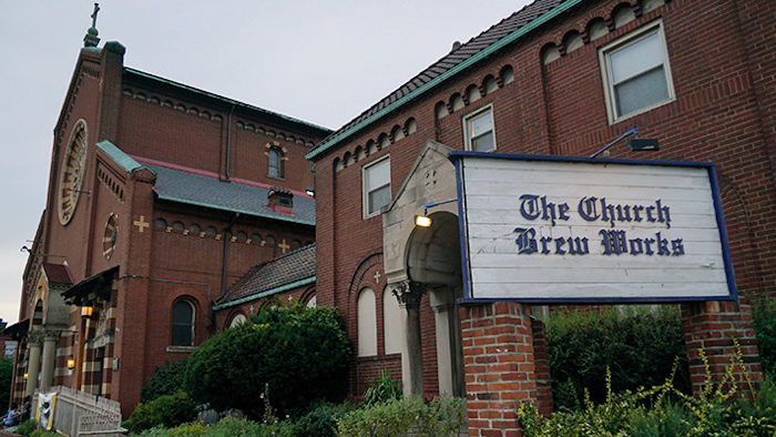 In this Aug. 7, 2017 photo, the Church Brew Works, a brewery operating in a renovated church, stands in Pittsburgh. At the Church Brew Works, an early church-turned-brewery that opened in 1996, patrons slide into booths crafted from pews. Breweries opening in renovated churches are winning fans but earning disapproval from clergy and worshippers across the U.S. (AP Photo/Dake Kang)