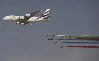 An Emirates Airline A-380 leads the 'Al Fursan', or the Knights, a UAE Air Force aerobatic display team, during the opening day of the Dubai Air Show, United Arab Emirates, Sunday, Nov. 12, 2017. The biennial Dubai Air Show opened Sunday with hometown long-haul carrier Emirates making a $15.1 billion buy of American-made Boeing 787-10 Dreamliners, as the world's biggest defense companies promoted their weapons amid heightened tensions between Saudi Arabia and Iran. (AP Photo/Kamran Jebreili)