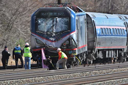 In this April 3 2016, file photo, Amtrak investigators inspect the deadly train crash in Chester, Pa. The Amtrak train struck a piece of construction equipment just south of Philadelphia causing a derailment. The National Transportation Safety Board is set to review the findings of an investigation into what caused a speeding Amtrak train to slam into a backhoe last year near Philadelphia, killing two maintenance workers. The board is meeting Tuesday, Nov. 14, 2017, in Washington to determine a probable cause of the deadly crash. (Michael Bryant/The Philadelphia Inquirer via AP, File)
