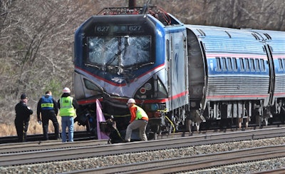 In this April 3 2016, file photo, Amtrak investigators inspect the deadly train crash in Chester, Pa. The Amtrak train struck a piece of construction equipment just south of Philadelphia causing a derailment. The National Transportation Safety Board is set to review the findings of an investigation into what caused a speeding Amtrak train to slam into a backhoe last year near Philadelphia, killing two maintenance workers. The board is meeting Tuesday, Nov. 14, 2017, in Washington to determine a probable cause of the deadly crash. (Michael Bryant/The Philadelphia Inquirer via AP, File)