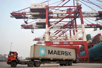 A truck moves a Maersk shipping container at a port in Qingdao in eastern China's Shandong Province. Chinese manufacturing activity improved in November, a survey showed Thursday, Nov. 30, 2017, adding to signs of a pickup in global and domestic demand. (Chinatopix via AP)