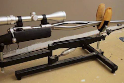 In this 2009 photo provided by Trent Procter, a Savage Arms stainless steel 10ML-II muzzleloader owned by Procter of Swan River, Manitoba, Canada, is displayed weeks after its barrel exploded and severely injured his left hand. Savage Arms recently agreed to pay a confidential settlement to Procter to resolve his lawsuit, one of several that allege the company kept a defective firearm on the market. (Gordon Harris/Trent Procter via AP)