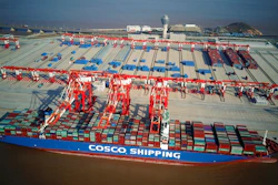 In this Dec. 6, 2017, aerial photo, a container ship is docked at the Yangshan Deep-Water Port near Shanghai, China. Chinese customs data show strong growth in both exports and imports last month in a reassuring sign for the world's second-biggest economy. (Chinatopix via AP)