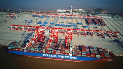 In this Dec. 6, 2017, aerial photo, a container ship is docked at the Yangshan Deep-Water Port near Shanghai, China. Chinese customs data show strong growth in both exports and imports last month in a reassuring sign for the world's second-biggest economy. (Chinatopix via AP)