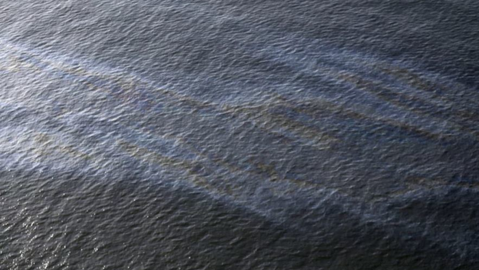 This March 31, 2015, file photo shows an oil sheen drifting from the site of the former Taylor Energy oil rig in the Gulf of Mexico, off the coast of Louisiana. (AP Photo/Gerald Herbert, File)