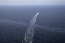 In this March 31, 2015 aerial photo, the wake of a supply vessel heading towards a working platform crosses over an oil sheen drifting from the site of the former Taylor Energy oil rig in the Gulf of Mexico, off the coast of Louisiana. Federal officials say they have found fresh evidence of an “ongoing oil release” at the site of a 13-year-old oil leak in the Gulf of Mexico, where chronic sheens often stretch for miles off Louisiana’s coast. In a court filing Friday, Dec. 15, 2017, government attorneys said recent surveys revealed two plumes of oil and gas flowing from where an underwater mudslide during Hurricane Ivan in 2004 toppled an offshore platform and buried the cluster of wells owned by Taylor Energy Corp. The company claims there is no evidence that oil is still leaking from its unplugged wells on the seafloor. (AP Photo/Gerald Herbert, File)