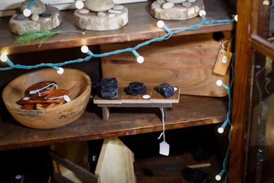Lumps of coal are sold as ornamental trinkets at the Winding Road Marketplace, a hub for selling the wares of local businesses, stands in his store, Thursday, Dec. 14, 2017, in Shawnee, Ohio. Communities across Appalachia are turning increasingly to the region's rich reserves in things other than coal, namely, history and rugged natural beauty, to frame a new tourist economy. Enjoying a drink, hike or overnight stay or in region infused with stories, sweat and strife is turning out to be a draw to aging baby boomers and millennials alike. Studies show these efforts are attracting tourists, new residents and a new sense of self-worth. (AP Photo/John Minchillo)