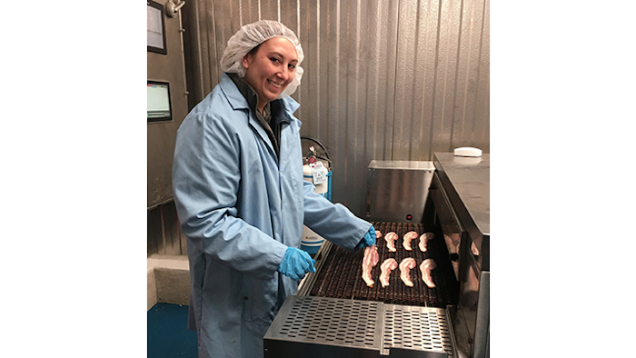 Research & Development Specialist, Rebecca Zollo, cooking a test batch of bacon in Godshall's new R&D center.