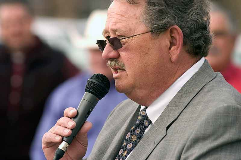 In this March 4, 2011 photo, Oklahoma Judge Thomas Landrith speaks at a dedication ceremony in Ada, Oka. The retired judge started his own rehab work camp where defendants must work full-time for free at a Coca-Cola bottling plant and other companies, under threat of prison. They are required to say they're unemployed and turn over their food stamps to the program, which state regulators say is fraud. Some of them even work on Landrith's yard — for free. (Richard R. Barron/The ADA News via AP)