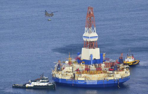 In this Jan. 7, 2013, file photo, a U.S. Army CH-47 Chinook helicopter flies over the Kulluk, the Shell floating drilling barge off Kodiak Island in Alaska's Kiliuda Bay, as salvage teams conduct an in-depth assessment of its seaworthiness. Citing the disappointing results from an exploratory well in 2015, and challenging and unpredictable federal regulatory environment, Shell abandoned drilling in U.S. Arctic waters. The Trump administration is pursuing petroleum lease sales in Arctic waters but an analyst says potential bidders may find other areas more attractive. (James Brooks/Kodiak Daily Mirror via AP, File)