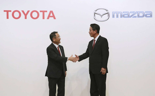 Toyota Motor Corp. President Akio Toyoda, left, and Mazda Motor Corp. President Masamichi Kogai shake hands after a press conference in Tokyo. Japanese automakers Toyota and Mazda have picked Alabama as the site of a new $1.6 billion joint-venture auto manufacturing plant, a person briefed on the decision said Tuesday, Jan. 9, 2018. (AP Photo/Eugene Hoshiko, File)