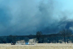 Smoke billows from the site of a gas well fire near Quinton, Okla., early Monday, Jan. 22, 2018. Several people are missing after a fiery explosion ripped through the eastern Oklahoma drilling rig, sending plumes of black smoke into the air and leaving a derrick crumpled onto the ground, an emergency official said. (Kevin Harvison/The McAlester News-Capital via AP)