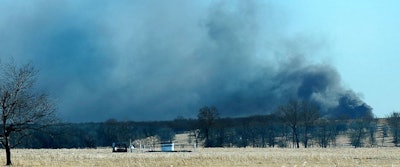 Smoke billows from the site of a gas well fire near Quinton, Okla., early Monday, Jan. 22, 2018. Several people are missing after a fiery explosion ripped through the eastern Oklahoma drilling rig, sending plumes of black smoke into the air and leaving a derrick crumpled onto the ground, an emergency official said. (Kevin Harvison/The McAlester News-Capital via AP)