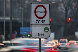 Cars pass by a sign reading 'environment zone' and allowing entrance just for cars with low emissions recognizable on a green sticker in Frankfurt, Germany, Thursday, Feb. 22, 2018. Image credit: Andreas Arnold/dpa via AP
