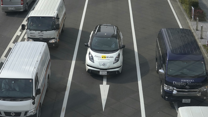 In this Wednesday, Feb. 21, 2018, photo, Nissan Motor Co.'s Easy Ride robo-vehicle, center, goes on a course during a test ride in Yokohama, near Tokyo. Image credit: AP Photo/Shizuo Kambayashi
