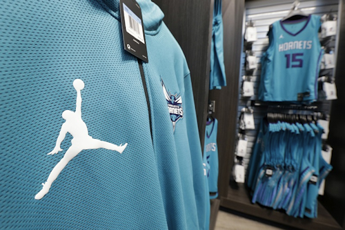 In this Oct. 17, 2017 file photo, The Michael Jordan 'Jumpman' logo is shown on merchandise at the Charlotte Hornets' NBA basketball fan store in Charlotte, N.C. Image credit: AP Photo/Chuck Burton, File