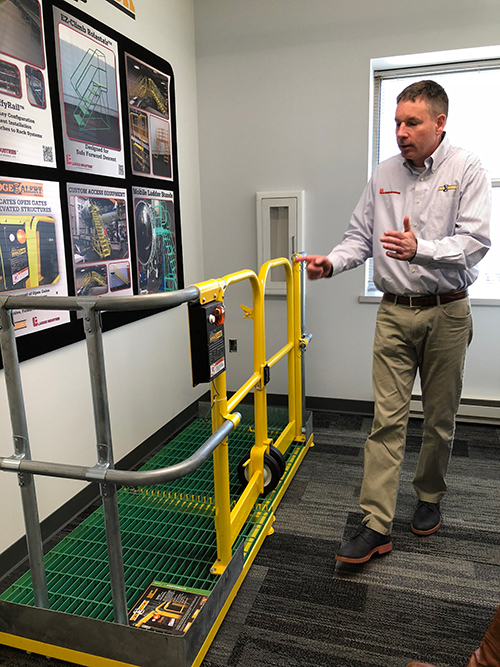 Paul Mihelich demonstrates Wildeck's EdgeAlert open gate alarm system that helps manufacturers maintain a safer work environment. (IMPO photo)