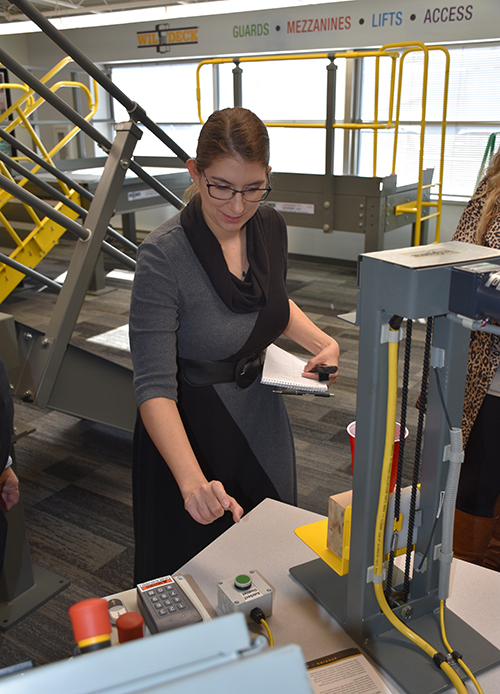 IMPO managing editor Rachelle Blair-Frasier tests Wildeck's patented AutoSenz on a VRC demo. (Wildeck Photo)