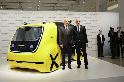 VW group CEO Matthias Mueller, left, and CFO Frank Witter, right, pose in front of a self driving concept car prior to the annual media conference of the Volkswagen group, in Berlin, Germany, Tuesday, March 13, 2018. Image credit: AP Photo/Markus Schreiber