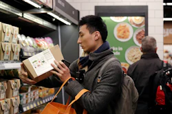 In this Jan. 22, 2018, file photo, customer Paul Fan shops at an Amazon Go store in Seattle. Image credit: AP Photo/Elaine Thompson, File