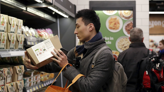 In this Jan. 22, 2018, file photo, customer Paul Fan shops at an Amazon Go store in Seattle. Image credit: AP Photo/Elaine Thompson, File
