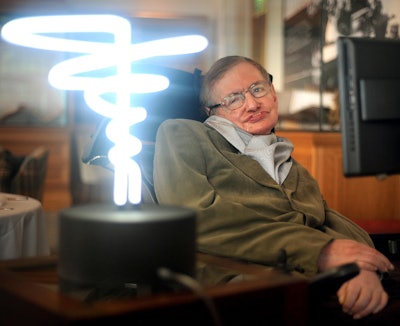 In this Feb. 25, 2012 photo, Professor Stephen Hawking poses beside a lamp titled 'black hole light' by inventor Mark Champkins, presented to him during his visit to the Science Museum in London. Image credit: Anthony Devlin/PA via AP