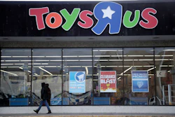 This Jan. 24, 2018, file photo shows a person walking near the entrance to a Toys R Us store, in Wayne, N.J. Image credit: AP Photo/Julio Cortez, File