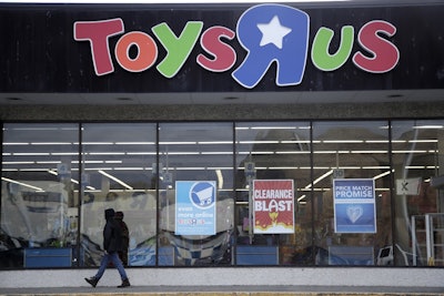 This Jan. 24, 2018, file photo shows a person walking near the entrance to a Toys R Us store, in Wayne, N.J. Image credit: AP Photo/Julio Cortez, File