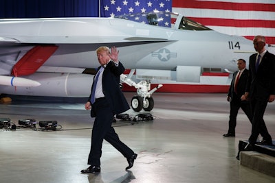 President Donald Trump waves as he walks off after participating in a roundtable discussion on tax policy at the Boeing Company, Wednesday, March 14, 2018, in St. Louis. Image credit: AP Photo/Evan Vucci