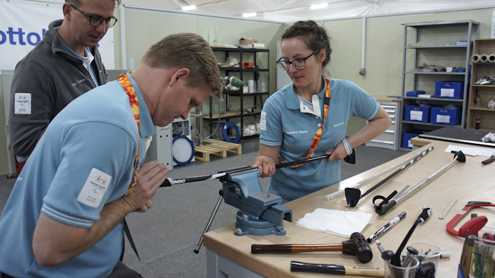 In this March 13, 2018, photo, John Spillar, second from left, one of Ottobock's American specialists who previously worked at the Parapan American Games and Invictus Games, works with an unidentified his colleague as Peter Franzel, left top, a director at Ottobock, watches at Pyeongchang's athletes' village in Pyeongchang, South Korea. Image credit: AP Photo/Kim Tong-hyung