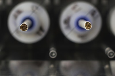 In this Thursday, Nov. 10, 2016 file photo, test cigarettes sit in a smoking machine in a lab at the Centers for Disease Control and Prevention in Atlanta. Image credit: P Photo/Branden Camp