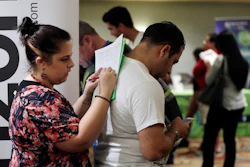In this Jan. 30, 2018 photo, Loredana Gonzalez, of Doral, Fla., fills out a job application at a JobNewsUSA job fair in Miami Lakes, Fla. Image credit: AP Photo/Lynne Sladky