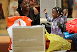 In this Dec. 21, 2017, file photo, Mercedes Amos, left, and her daughter Jhene Rivers, 2, right, of Orangeburg, S.C., rest after a day of holiday shopping at Concord Mills mall in Concord, N.C. Image credit: AP Photo/Chuck Burton, File