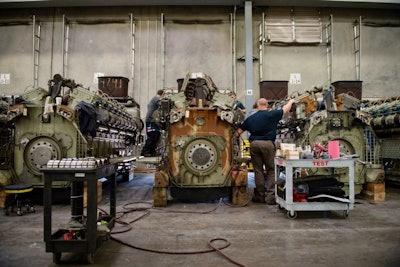 Norfolk Southern locomotives, one refurbished and one awaiting refurbishment, sit side-by-side at the Fort Worth GE factory. Image credit: GE Transportation