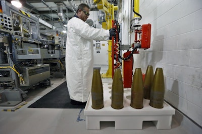 In this Jan. 29, 2015, file photo, an ordnance technician uses a robot to to handle inert simulated chemical munitions used for training at the Pueblo Chemical Depot, east of Pueblo, in southern Colorado. Image credit: AP Photo/Brennan Linsley, File