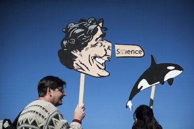 Scott McBride holds a caricature of Prime Minister Justin Trudeau during a protest against the Kinder Morgan Trans Mountain pipeline expansion in Burnaby, British Columbia, Canada, on Saturday March 10, 2018. Indigenous people and environmental activists are vowing to block a $7.4 billion pipeline expansion that would pump oil from Canada's tar sands to the Pacific Coast. Thousands are expected to rally on Saturday, kicking of a series of mass actions. (Darryl Dyc /The Canadian Press via AP)