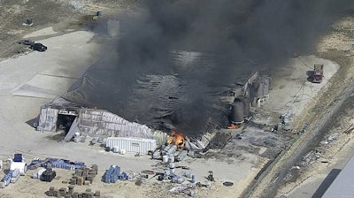 In this image from video by KDFW, a fire burns at the Tri-Chem Industries plan in Cresson, Texas. Officials said fears of another blast amid the toxic chemicals prevented crews from battling the blaze. (KDFW via AP)