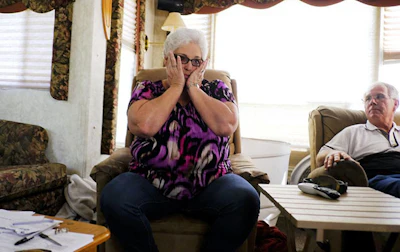 In this March 18, 2018 photo, Diane Glover talks about waiting for a new home as her husband, Nolan, listens in their trailer in Crosby, Texas. The couple's home, close to the Arkema plant, was destroyed by Hurricane Harvey so they are living in a trailer while awaiting a new one. (Elizabeth Conley/Houston Chronicle via AP)