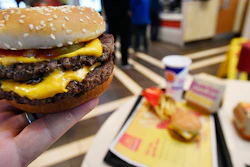 A McDonald's Double Quarter Pounder is shown with the new fresh beef Tuesday, March 6, 2018, in Atlanta. McDonald's is offering fresh beef rather than frozen patties in some burgers at thousands of restaurants, a switch it first announced about a year ago as it works to appeal to customers who want fresher foods. (AP Photo/Mike Stewart)