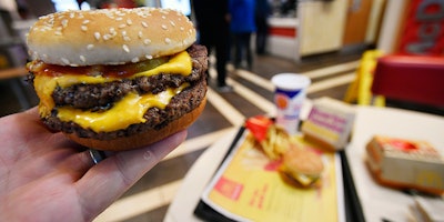 A McDonald's Double Quarter Pounder is shown with the new fresh beef Tuesday, March 6, 2018, in Atlanta. McDonald's is offering fresh beef rather than frozen patties in some burgers at thousands of restaurants, a switch it first announced about a year ago as it works to appeal to customers who want fresher foods. (AP Photo/Mike Stewart)